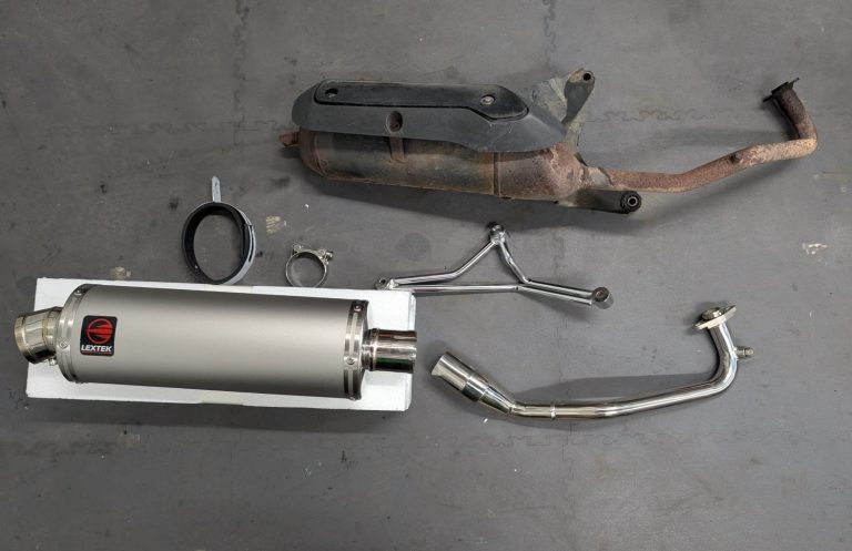A picture showing old scooter exhaust compared to a brand new performance exhaust system.